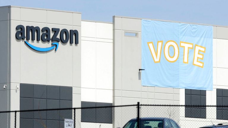 A banner encouraging workers to vote in labor balloting is shown at an Amazon warehouse in Bessemer, Ala., on Tuesday, March 30, 2021. Organizers are pushing for some 6,000 Amazon workers to join the Retail, Wholesale and Department Store Union on the promise it will lead to better working conditions, better pay and more respect. Amazon is pushing back, arguing that it already offers more than twice the minimum wage in Alabama and workers get such benefits as health care, vision and dental insur