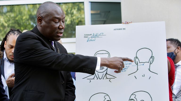 Ben Crump points to a diagram of the fatal gunshot in the back of Andrew Brown Jr&#39;s head following the findings of an independent post-mortem