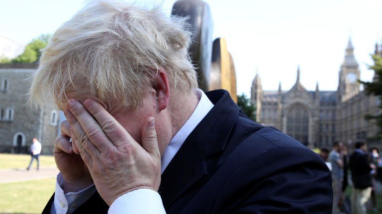 Boris Johnson speaks on the phone in central London