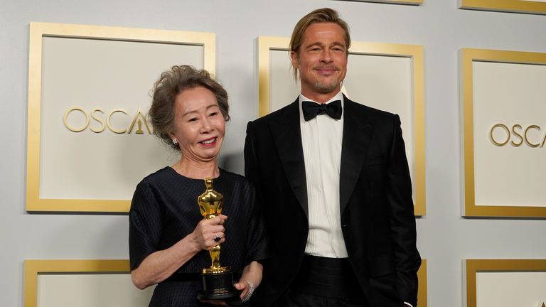 Brad Pitt, right, poses with Yuh-Jung Youn, winner of the award for best actress in a supporting role for "Minari," in the press room at the Oscars on Sunday, April 25, 2021, at Union Station in Los Angeles. (AP Photo/Chris Pizzello, Pool)