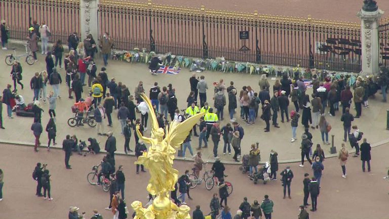 People lay flowers outside Buckingham palace to pay tribute to Prince Philip