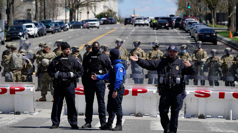 Members of the U.S. Capitol Police stand guard near the scene of a car that crashed into a barrier on Capitol Hill in Washington, Friday, April 2, 2021. (AP Photo/Patrick Semansky)