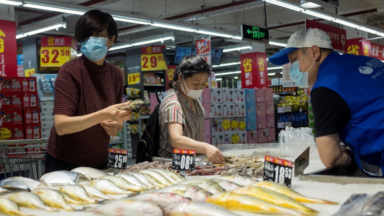 People look at fresh seafood in a supermarket following an outbreak of the coronavirus disease (COVID-19) in Beijing, China, August 13, 2020