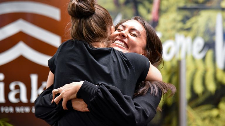 Families and loved ones embrace after arriving on the first Air New Zealand flight to land as quarantine-free travel between Australia and New Zealand begins, in Wellington, New Zealand
