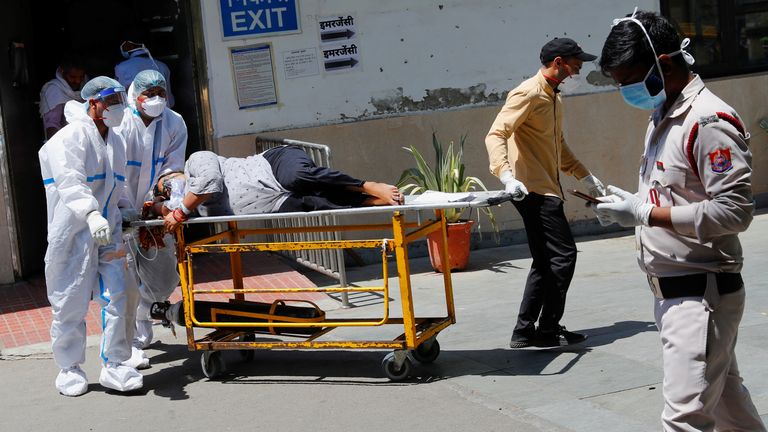 Health workers transporting a coronavirus patient in Delhi