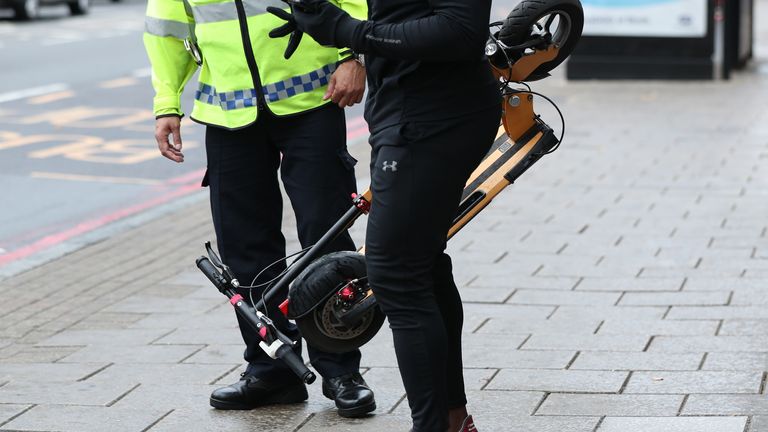 An e-scooter rider is stopped by a police officer in Islington, London
