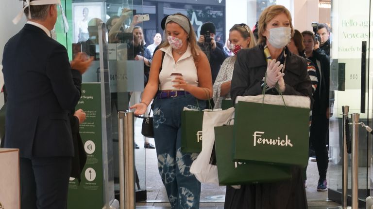 Julie Siow, the first customer through the doors, receives a round of applause from the staff at the Fenwick store in Newcastle, as non-essential shops in England open their doors to customers for the first time since coronavirus lockdown restrictions were imposed in March 15/6/2020