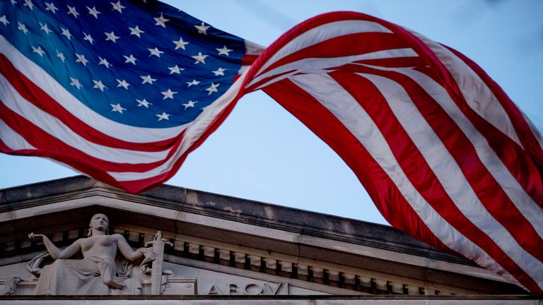 An American flag flies outside the Department of Justice in Washington, Friday, March 22, 2019. Special counsel Robert Mueller has concluded his investigation into Russian election interference and possible coordination with associates of President Donald Trump. The Justice Department says Mueller delivered his final report to Attorney Barr, who is reviewing it. (AP Photo/Andrew Harnik)