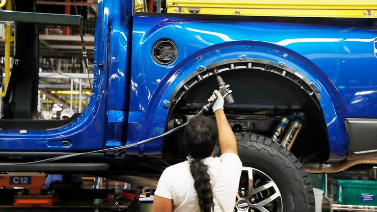 In this Sept. 27, 2018, file photo a United Auto Workers assemblyman works on a 2018 Ford F-150 truck being assembled at the Ford Rouge assembly plant in Dearborn, Mich.  Pic: AP