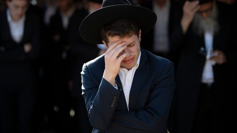 Ultra-Orthodox Jews mourn during the funeral of Moshe Ben Shalom. Pic: AP