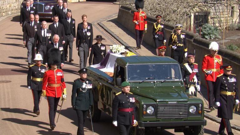 The royal family walk behind the coffin