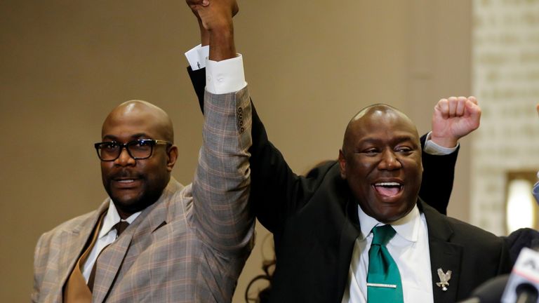 Philonise Floyd (left) raises his hand in celebration with family lawyer Ben Crump 