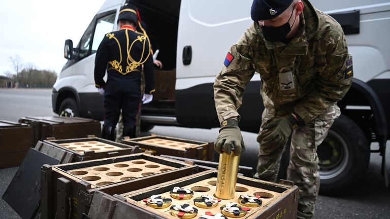 A member of The King&#39;s Troop Royal Horse Artillery places empty shells into boxes ahead of a gun salute