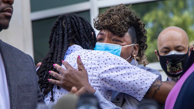 Eric Garner&#39;s mother, Gwen Carr hugs Andrew Brown Jr&#39;s son Khalil Ferebee. Pic: AP