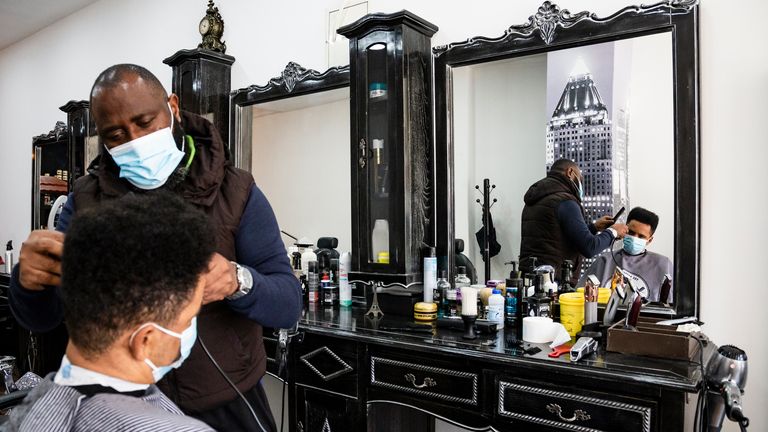 A hairdresser wearing a face mask cuts a costumers hair short at a barbershop amid coronavirus crisis. On March 11, the deconfination program was announced and will be gradually, divided into 4 parts, in a period that goes until Easter, and may have setbacks. Starting this Monday with the opening of kindergartens, 1st cycle, hairdressers, manicurists, real estate, bookstores and wicket coffee service. (Photo by Rita Franca / SOPA Images/Sipa USA)