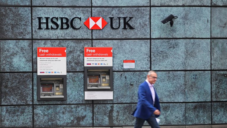 A worker walks past a branch of HSBC bank in the City of London financial district in London September 4, 2017. REUTERS/Toby Melville
