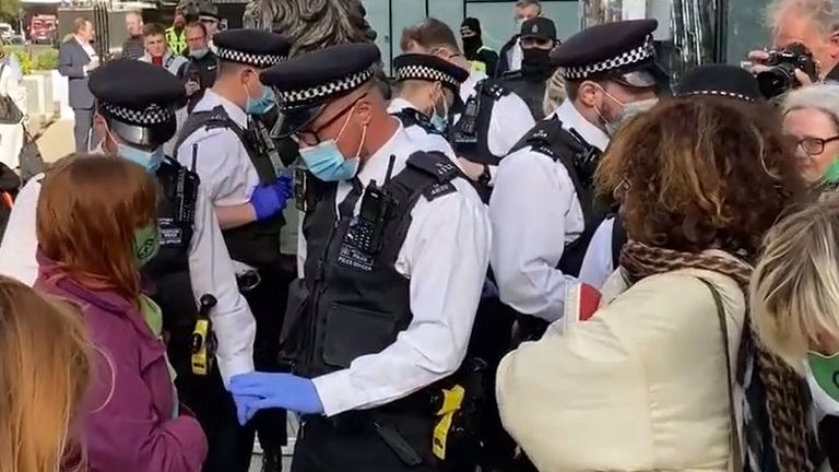 Extinction Rebellion activists are arrested in London after smashing windows on HSBC building