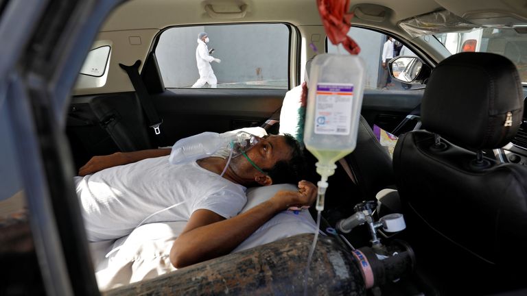 A patient in a car waits to enter a Ahmedabad hospital for COVID treatment