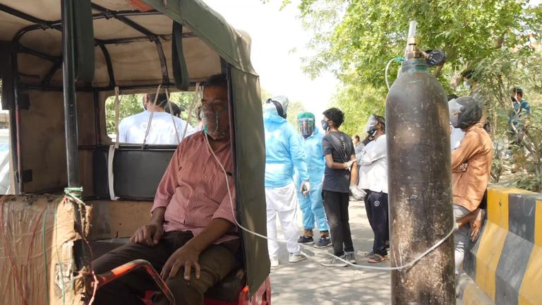 Dozens of vehicles are crammed outside a Sikh temple