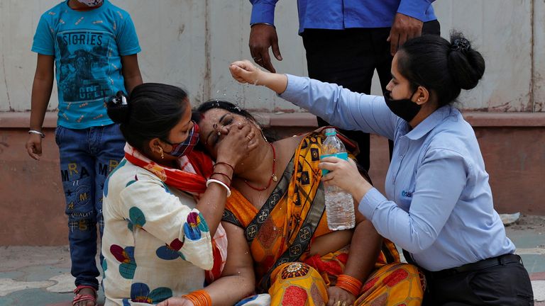 A mourner is consoled after her husband died of COVID-19 in New Delhi. India recorded 200,000 cases on 16 April