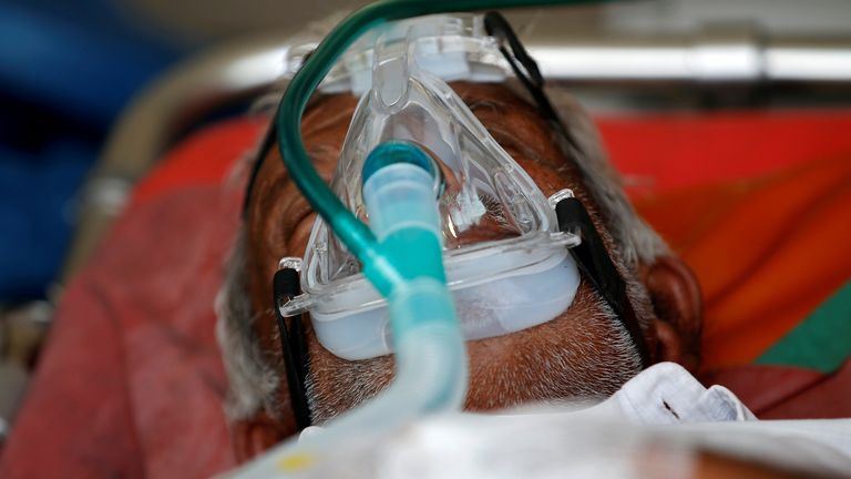 A patient wearing an oxygen mask waits in an ambulance to enter a hospital in Ahmedabad, India. Pic: Reuters