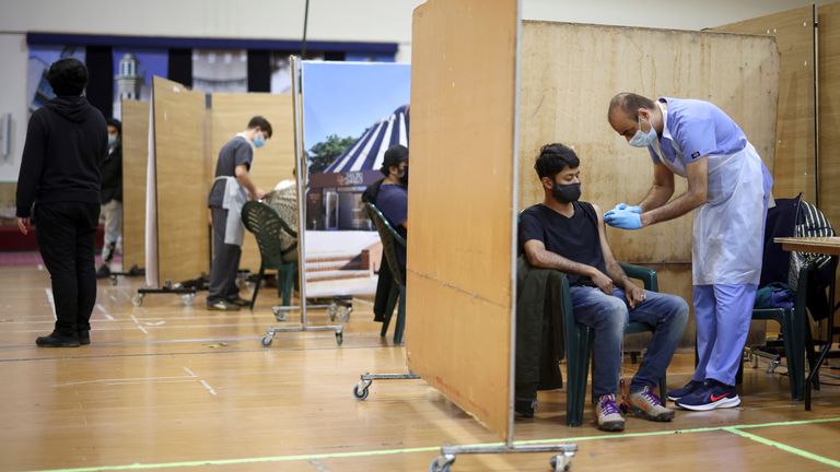 A man receives an AstraZeneca jab at a coronavirus vaccination centre in London&#39;s Baitul Futuh Mosque