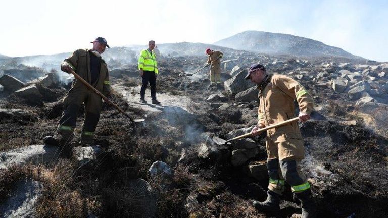 Firefighters among the burned out gorse in the Mourne Mountains. Pic: Department of Agriculture via PA