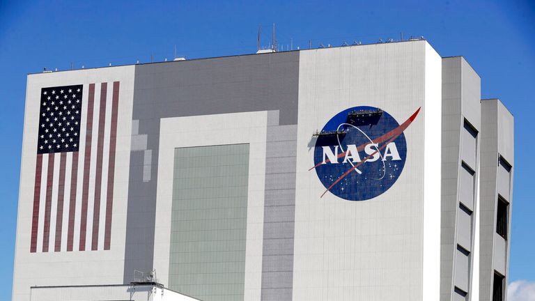 Workers near the top of the 526 ft. Vehicle Assembly Building at the Kennedy Space Center spruce up the NASA logo standing on scaffolds in Cape Canaveral, Fla., Wednesday, May 20, 2020. A SpaceX Falcon 9 rocket scheduled for May 27 will launch a Crew Dragon spacecraft on its first test flight with astronauts on-board to the International Space Station. (AP Photo/John Raoux)


