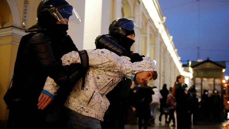 A demonstrator is taken away by law enforcement officers during a rally in support of jailed Russian opposition politician Alexei Navalny