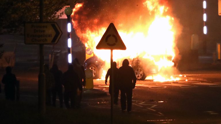 Masked loyalists after hijacking and setting a car on fire at the Cloughfern roundabout in Newtownabbey