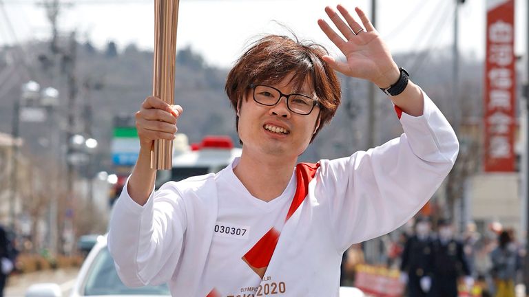 Former road relay runner Ryuji Kashiwabara takes part in the Tokyo Olympic torch relay Shirakawa, northeastern Japan. Pic: AP