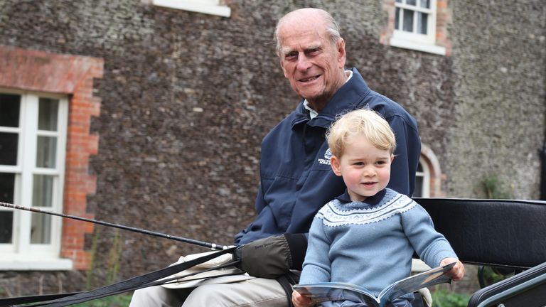 Kensington Palace shared a touching new photograph of a young Prince George with his great-grandfather Philip alongside the message from William