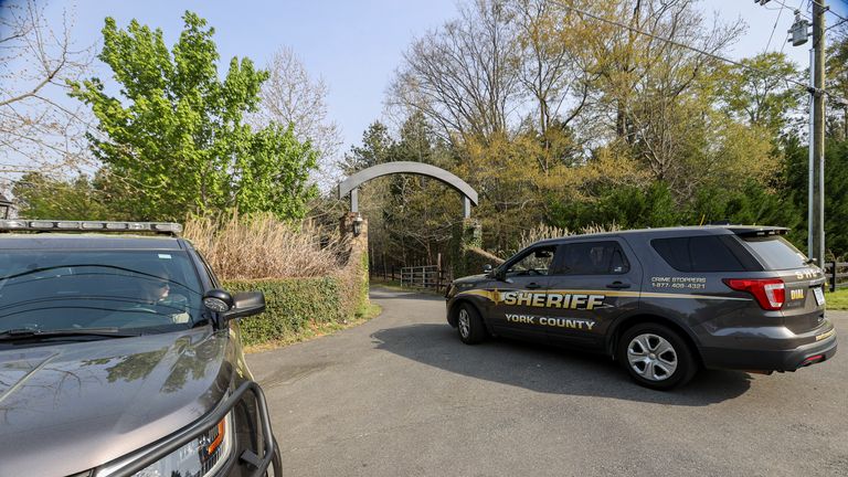 A York County sheriff vehicle drives onto the property where multiple people, including a prominent doctor, were fatally shot a day earlier, Thursday, April 8, 2021, in Rock Hill, S.C. A source briefed on the mass killing said the gunman was former NFL player Phillip Adams, who shot himself to death early Thursday. (AP Photo/Nell Redmond)