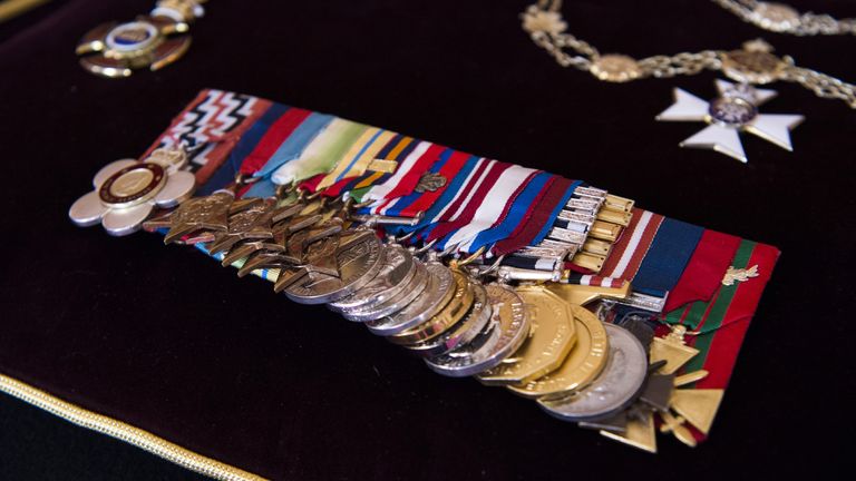 Detail of the Order of Merit, the Royal Victorian Chain and full size Medal Group, sewn onto a cushion in St James&#39;s Palace