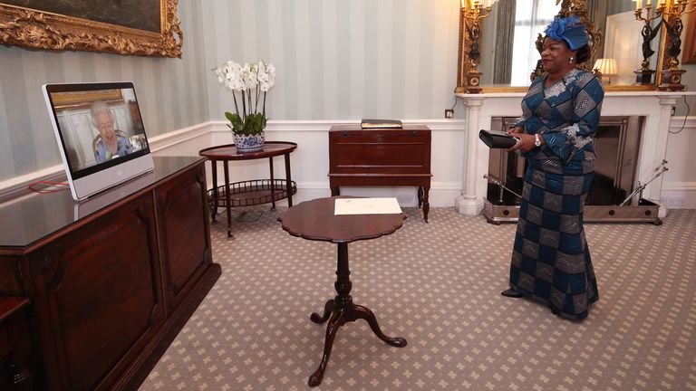 Queen Elizabeth II appears on a screen by videolink from Windsor Castle, where she is in residence, during a virtual audience to receive Her Excellency Sara Affoue Amani, the Ambassador of Cote d'Ivoire, at Buckingham Palace, London. Picture date: Tuesday April 27, 2021.
