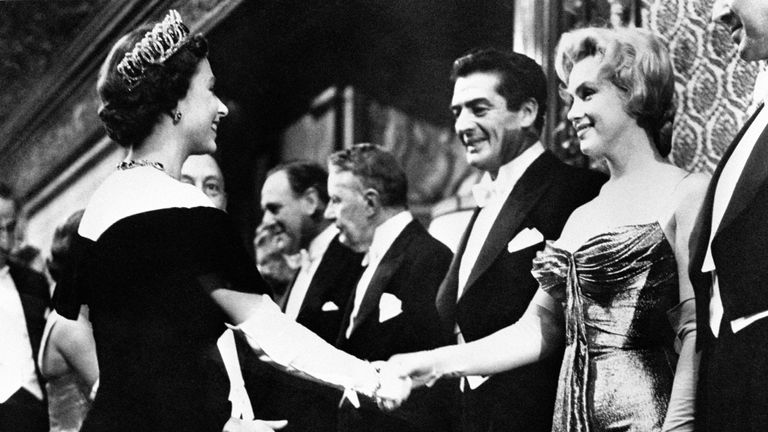 Marilyn Monroe, shaking hands with the Queen at the Empire Theatre, Leicester Square, on the occasion of the 1956 Royal Film Performance.