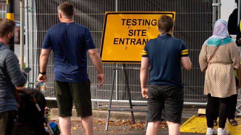 People queue at a coronavirus testing facility in Sutton Coldfield, Birmingham