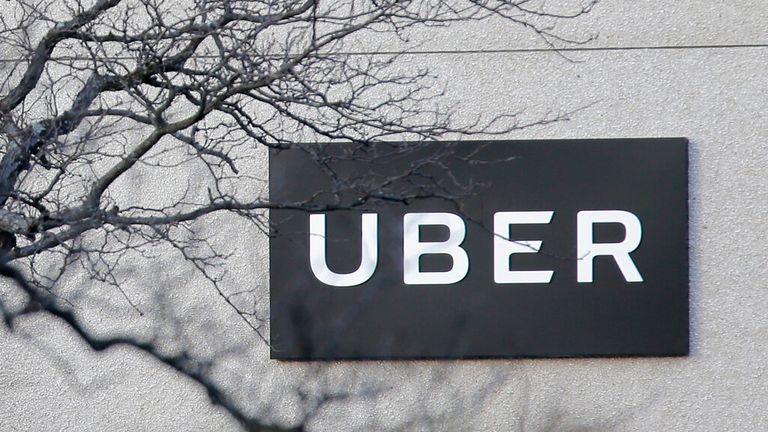 FILE - In this Nov. 15, 2019, file photo is an Uber office in Secaucus, New Jersey, USA. Ride hailing giant Uber says it’s giving U.K. drivers benefits after losing a yearslong court battle to prevent them from being classified as “workers.” The company says drivers will now get the minimum wage, pensions and holiday pay, after the U.K.&#39;s top court ruled that drivers should be classed as workers and not self-employed. The union behind the case said drivers should also be paid for time logged in 