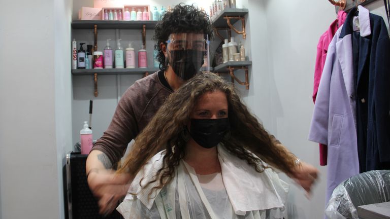 Stylist Danny Law with customer Amy Smith, who is visiting a hairdresser for the first time in more than a year, at the Strand & Lock salon in Birmingham&#39;s creative Digbeth quarter , on the first day of reopening following the further easing of lockdown restrictions. Picture date: Monday April 12, 2021.