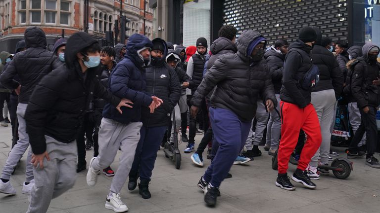 Early morning shoppers gather outside the JD Sports store in Oxford Street, London, waiting for the store to reopen as England takes another step back towards normality with the further easing of lockdown restrictions. Picture date: Monday April 12, 2021.