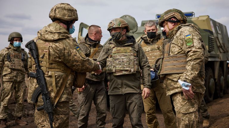 Ukrainian President Volodymyr Zelenskiy shakes hands with a soldier as he visits the war-hit Donetsk region, eastern Ukraine, Thursday, April 8, 2021. Ukraine&#39;s president is visiting the area of conflict in his country&#39;s east amid an escalation of tensions that has raised fears of a resumption of large-scale hostilities. (Ukrainian Presidential Press Office via AP)