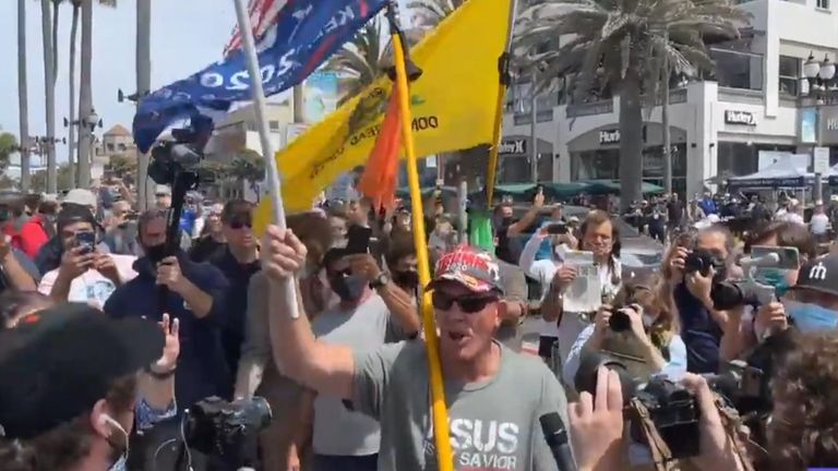 A crowd of White Lives Matter protesters and antiracism counterprotesters filled the streets near the Huntington Beach pier on Sunday, but quickly dispersed after police declared an unlawful assembly