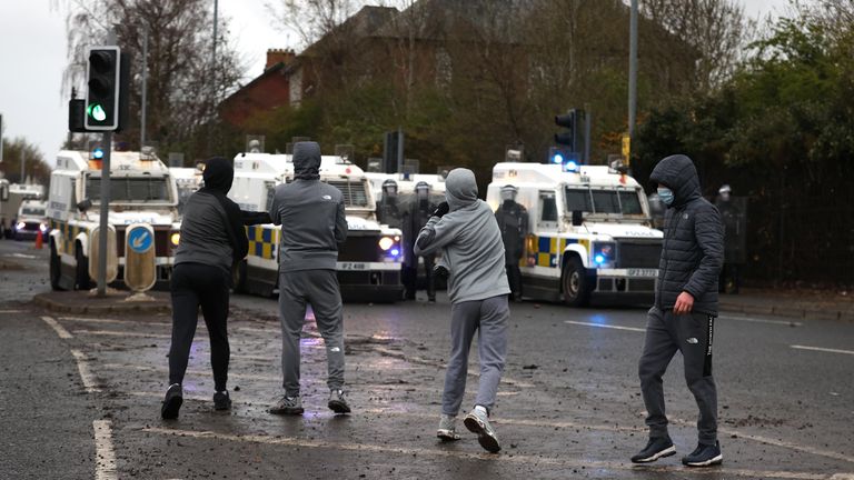 Youths throw stones towards PSNI officers on the Springfield road, during further unrest in Belfast. Picture date: Thursday April 8, 2021.