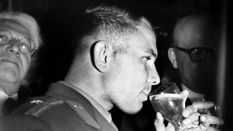 FILE - In this Thursday, July 13, 1961 file photo, Yuri Gagarin, the Soviet cosmonaut, sips a cool drink at a reception in his honor at Hyde Park Hotel, London. The successful one-orbit flight on April 12, 1961 made the 27-year-old Gagarin a national hero and cemented Soviet supremacy in space until the United States put a man on the moon more than eight years later. (AP Photo/Bob Dear, File)
