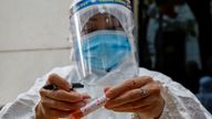 FILE PHOTO: A health worker labels a test-sample tube during the coronavirus outbreak in Hanoi, Vietnam, January 29, 2021. REUTERS/Kham/File Photo