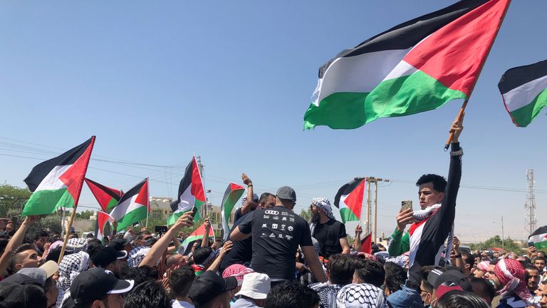 Demonstrators hold Palestinian flags during a protest to express solidarity with the Palestinian people, in Karameh, Jordan valley, Jordan May 14, 2021. REUTERS/Jehad Shelbak