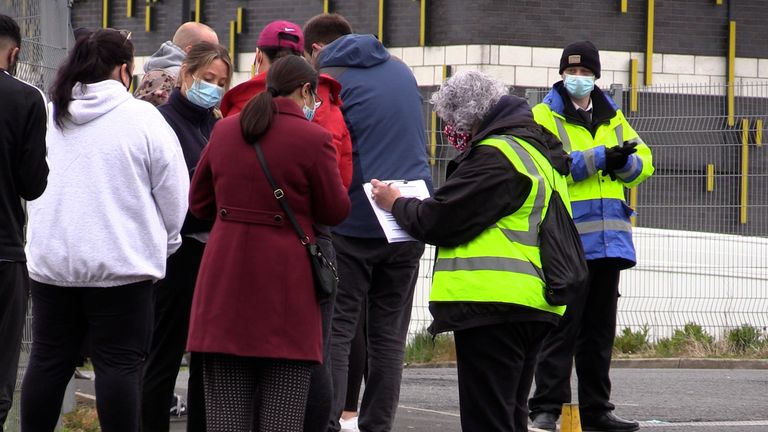 People queue for the vaccination centre at the Essa Academy in Bolton. The Indian coronavirus variant has been detected in a number of areas in England, including Bolton, which are reporting the highest rates of infection, data suggests. Picture date: Friday May 14, 2021.