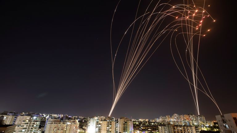 Streaks of light are seen in Ashkelon as Israel&#39;s Iron Dome anti-missile system intercepts rockets launched from the Gaza Strip towards Israel