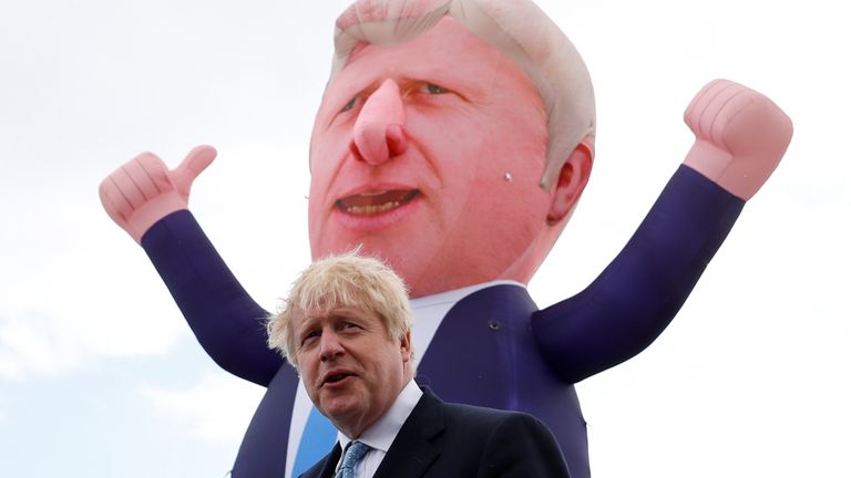  Prime Minister Boris Johnson speaks, with an inflatable figure depicting him in the background, at Jacksons Wharf Marina in Hartlepool following local elections