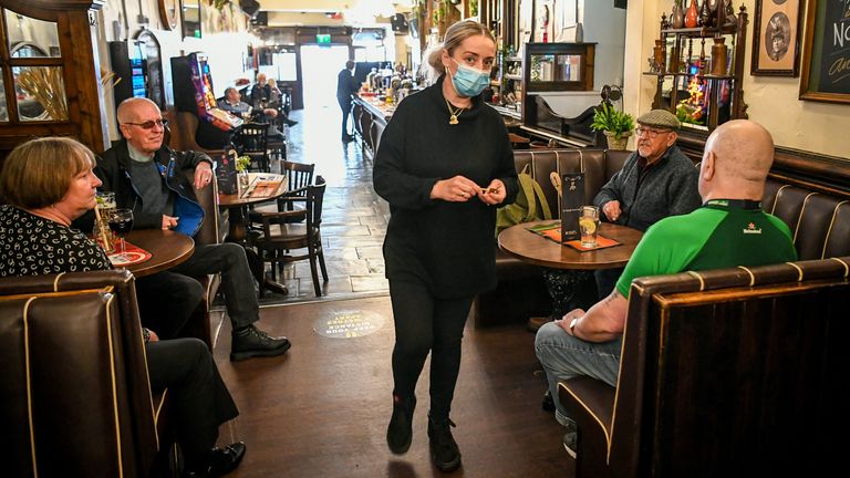 Staff serve at tables inside The Borough pub on St Mary&#39;s Street, Cardiff